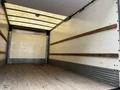 2018 Hino 195 box truck interior with wooden rails along the walls and a wooden floor empty of cargo