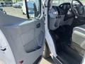 A 2016 Ford Transit van with an open door displaying the driver's seat and interior controls