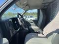 Interior of a 2013 Chevrolet Express showing the steering wheel and front seats