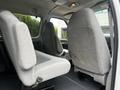 Interior of a 2008 Ford Econoline showing two front seats and two rear seats with gray upholstery