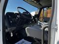 Interior view of a 2012 Freightliner M2 112 with a steering wheel dashboard controls and driver seat visible