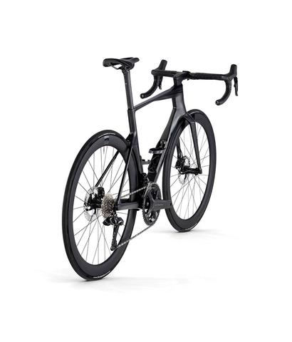A 2024 BMC Teammachine R 01 Four Road Bike with a sleek black frame aerodynamic design and disc brakes showcasing a modern cycling aesthetic
