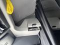 Interior view of a 2022 Freightliner Cascadia showing a storage compartment and a grey wall panel