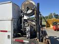 A 2007 International 7300 truck with a mounted hose reel and various industrial components on the back of the vehicle