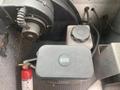 A 2012 Ford Econoline with visible mechanical components including a black container and a fire extinguisher
