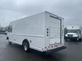 A white 2012 Ford Econoline commercial box truck seen from the rear showing its rectangular cargo area and taillights