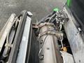 Close-up of the engine compartment of a 2014 John Deere 1585 Terrain Cut showing the air filter housing and various mechanical components