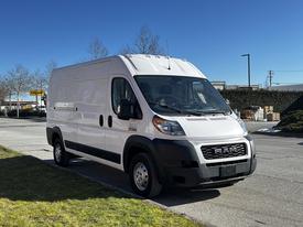 A white 2019 RAM Promaster van parked with a high roof and large cargo area visible