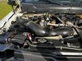 Engine compartment of a 2018 Ford F-550 showcasing the air intake and various engine components with visible hoses and a battery