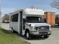 2010 Ford Econoline with a white exterior and large side door open, front end featuring a prominent grill and headlights