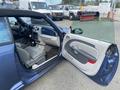 A 2007 Chrysler PT Cruiser with its driver's side door open showing the interior features and seating arrangement