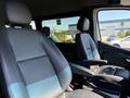 Interior view of a 2023 Mercedes-Benz Sprinter featuring two leather front seats with armrests and a sleek design