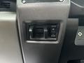 Close-up of the control panel in a 2018 Ford F-550 featuring two rocker switches with a plus and minus symbol for adjusting settings