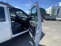 A white 2016 Ford F-350 SD with an open driver's side door revealing the interior features such as seats and dashboard