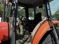 Interior of a 2011 Kubota M8540D tractor showing the driver's seat control panel and steering wheel