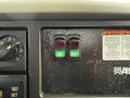 Dashboard of a 2011 International 4300 featuring two switches one green and one red with labels for power take-off and strobes