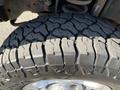 Tread of a large off-road tire from a 2014 Ford F-350 SD showing deep grooves and rugged design for enhanced traction