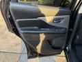 A black 2021 Nissan Murano driver's side door with a padded armrest and door handle visible