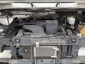 View of the engine compartment of a 2012 Ford Econoline showing the engine components and wiring without any visible exterior features