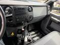The interior dashboard of a 2017 Ford F-750 featuring controls for audio navigation and climate with a prominent display and various buttons and knobs