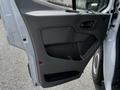 The image shows the interior door panel of a 2022 Ford Transit featuring a handle, button controls, and storage compartment