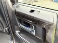 Interior door handle of a 2021 Toyota 4Runner featuring a sleek design with a button above the handle
