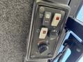 Control panel of a 2010 Kubota F3990 featuring various switches and dials for operating functions
