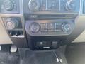 Dashboard controls of a 2017 Ford F-150 featuring air conditioning settings volume and tuning buttons and a USB port