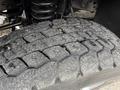 Close-up of a worn tire on a 2007 Ford F-550 showing visible tread patterns and dirt embedded in the surface