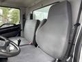 Interior of a 2017 Hino 338 featuring two gray fabric seats and a steering wheel with controls
