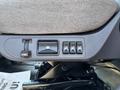 Close-up of the control panel on a 2015 Freightliner M2 106 featuring three buttons and a lever for various functions