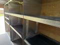 A 2016 Ford Transit with multiple metal shelves inside the cargo area designed for storage and transport purposes
