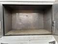 An empty metal cargo area of a 2012 Workhorse W62 with smooth, dull surfaces and no visible items inside