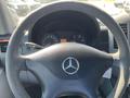 Steering wheel of a 2010 Mercedes-Benz Sprinter featuring the Mercedes logo and dashboard with speedometer and other gauges