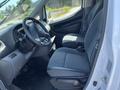Interior view of a 2019 Nissan NV200 showing two front seats and the dashboard with steering wheel and controls