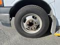 A close-up view of a tire on a 2017 Chevrolet Express showing the wheel rim and lug nuts with a Michelin tire visible