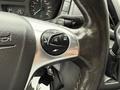 Close-up of the steering wheel control panel of a 2017 Ford Transit T150 XLT featuring buttons for cruise control and audio functions