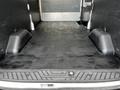 A 2020 Ford Transit van interior with a flat black floor and two raised wheel wells on either side