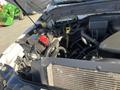 Close-up of the engine compartment of a 2013 Ford F-250 SD showing the battery, hoses, and various engine components