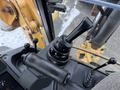 A close-up view of the joystick controls inside a 2011 John Deere 310SJ 4x4 Wheel Loader Extended Hoe 4 in 1 machine
