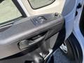 A close-up of the driver's side door panel of a 2016 RAM Promaster featuring window controls and a handle