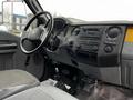 Interior view of a 2013 Ford F-650 showing the steering wheel dashboard and gear shifter with controls and audio system details visible