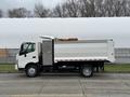 A 2014 Hino 195 truck with a white cargo bed and a partially opened rear hatch is parked on the street