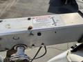A 2008 Ford Econoline van displayed from an elevated angle showing its side with a visible warning label on a metal structure