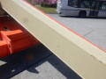 A 2008 JLG Boom Lift featuring a long beige arm with an orange base and visible wear marks on the surface