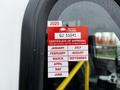 A 2016 Ford Econoline with a sticker displaying a certificate of approval and months listed for vehicle inspection