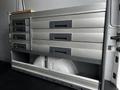 A metal storage unit with multiple drawers installed in the interior of a 2017 Mercedes-Benz Sprinter van