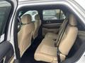 Interior view of a 2016 Ford Explorer showing the back row of beige seats with seat belts attached