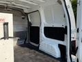A 2021 Nissan NV200 van interior showing the cargo area with a white wall and black floor covering