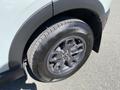Close-up of a 2023 Ford Bronco Sport wheel featuring a black tire with the brand name and model printed on the sidewall and a sleek alloy wheel design